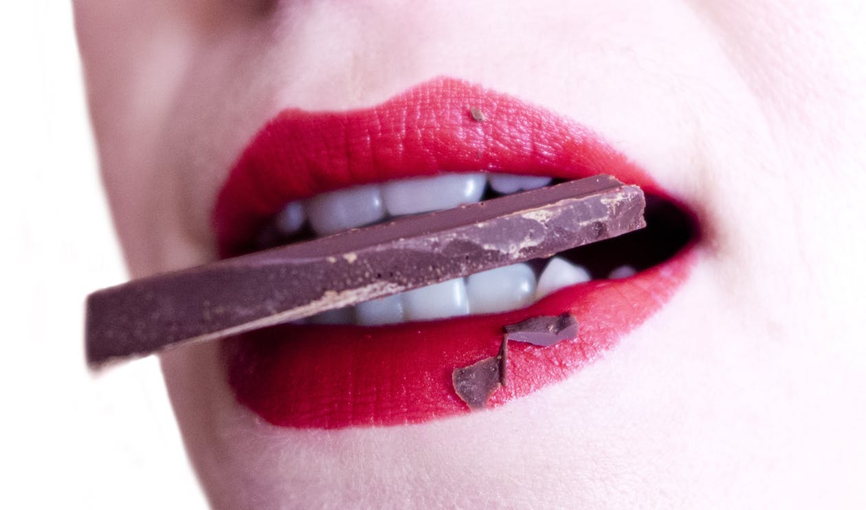 woman biting chocolate